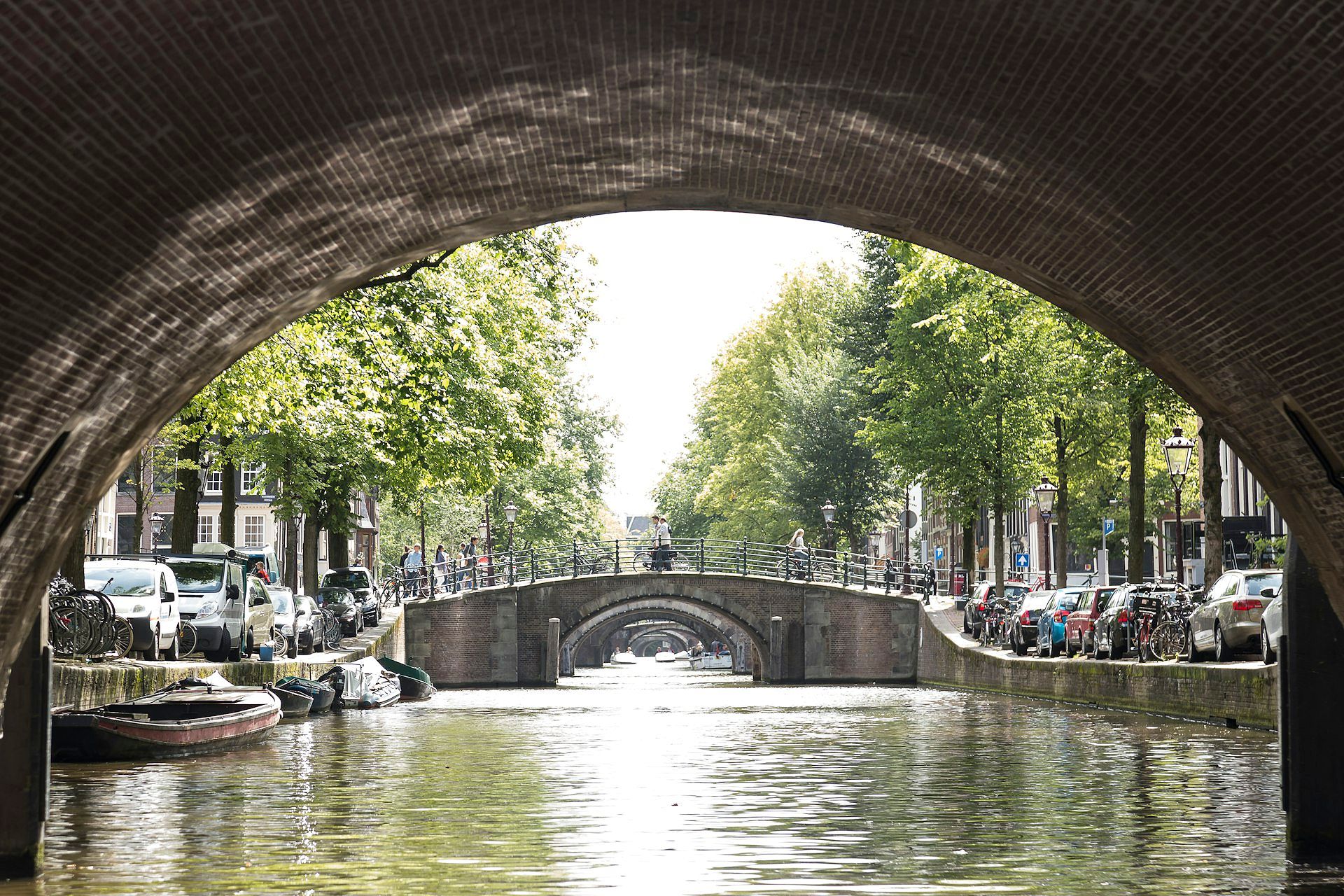 View from underneath a bridge shows the canals and bridges of Amsterdam